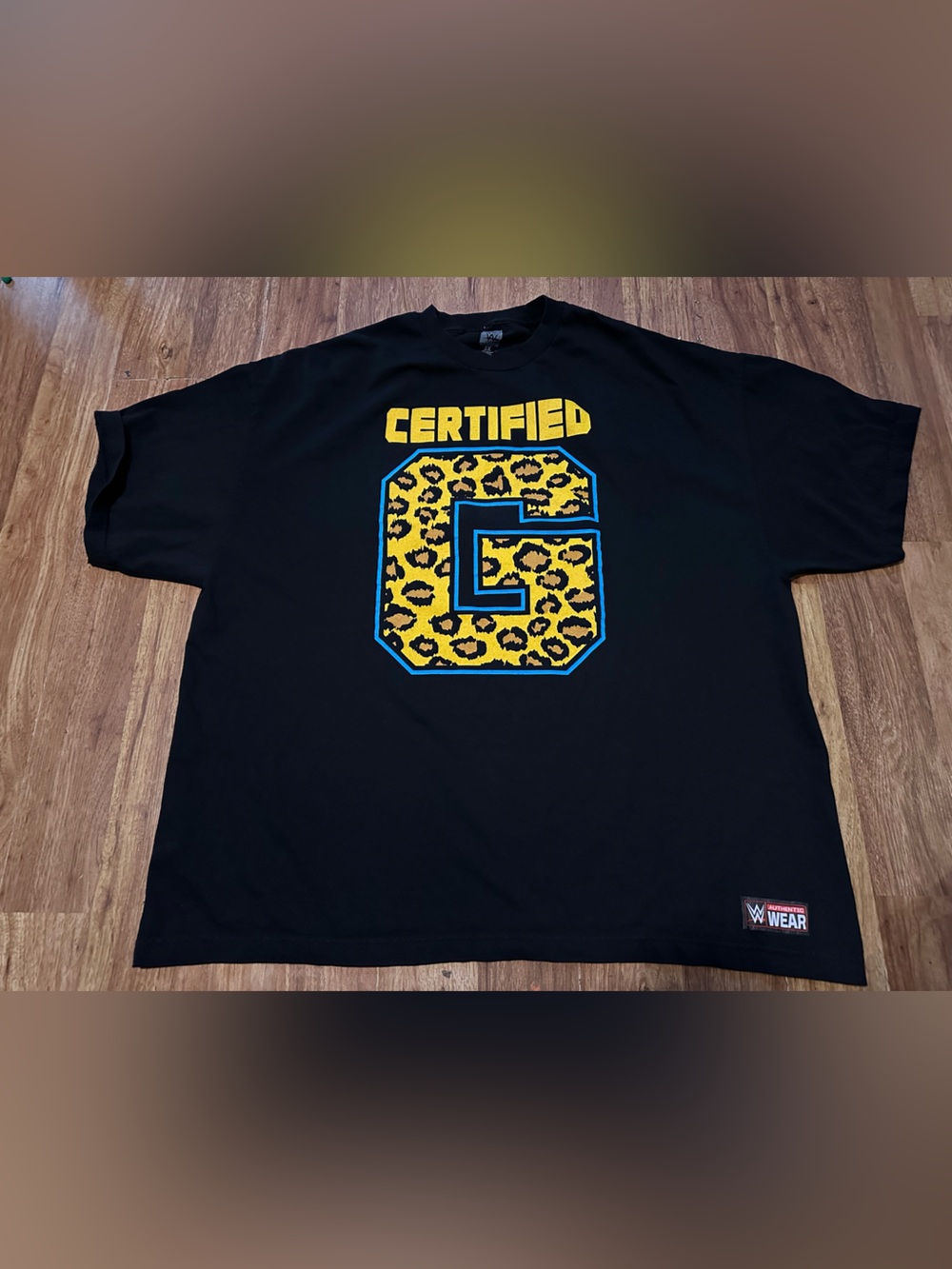 WWE Certified Leopard 'G' Graphic Tee - Black with Yellow & Blue Accents